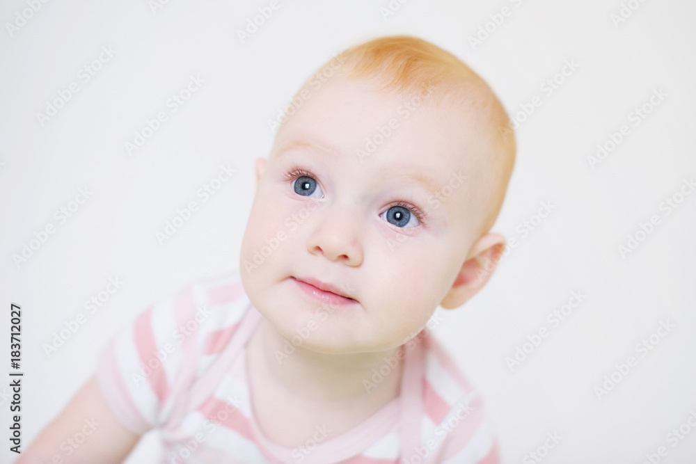 Little red-haired girl on a white background
