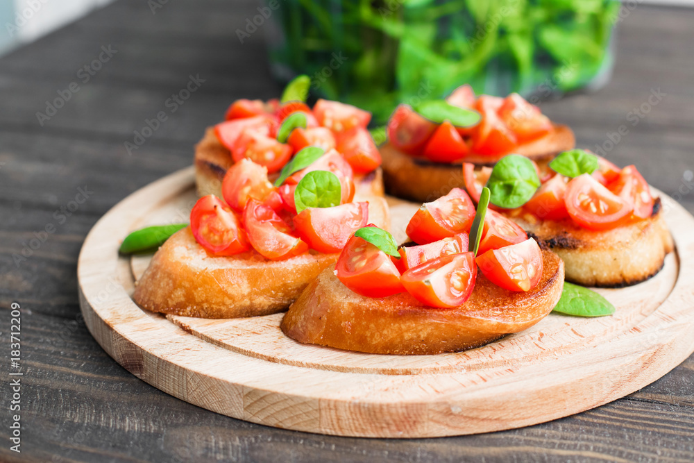 Traditional Italian bruschetta with tomatoes and spinach Traditional Italian bruschetta with tomatoes and spinach