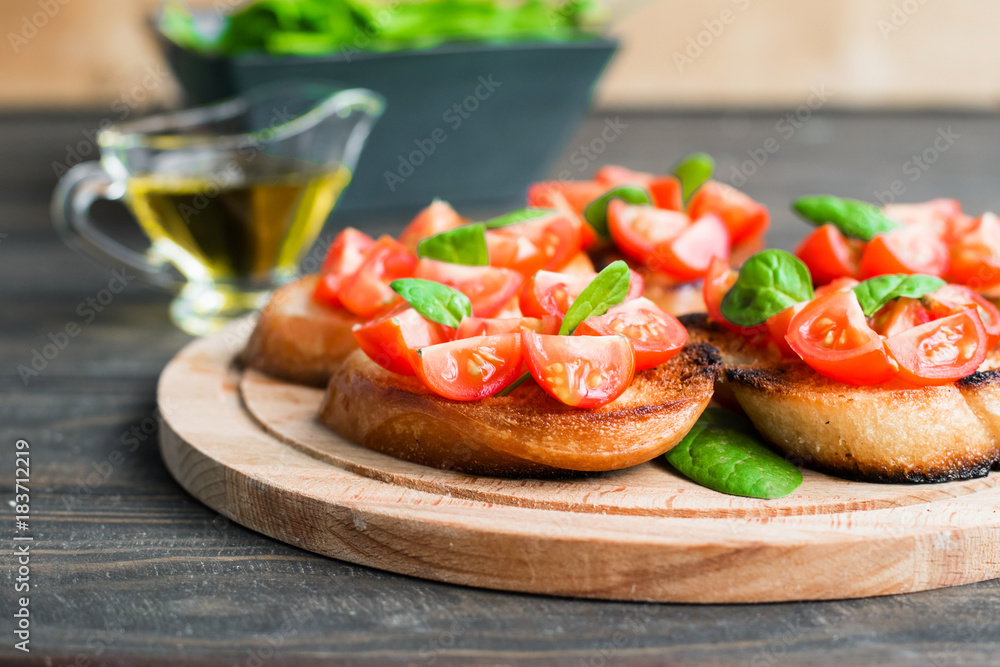 Traditional Italian bruschetta with tomatoes and spinach Traditional Italian bruschetta with tomatoes and spinach