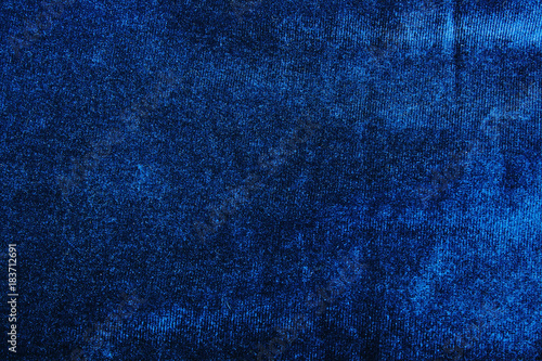 Velvet dress material cloth texture pattern. Blue velvet tailoring stitching concept. Shiny beautiful fashion fabric. Shiny clothing material sample.Creased fabric. Fashion fabric macro photo.