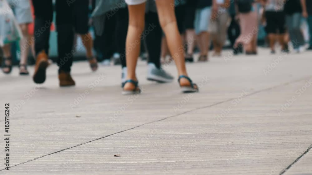 People pedestrians walk cross big city. Footsteps of a crowd of people go on business in the metropolis People pedestrians walk cross big city. Footsteps of a crowd of people go on business in the metropolis