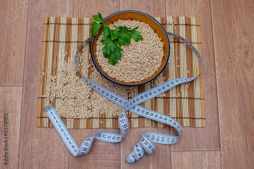 Wooden ware of folk art with pearl barley and centimeter