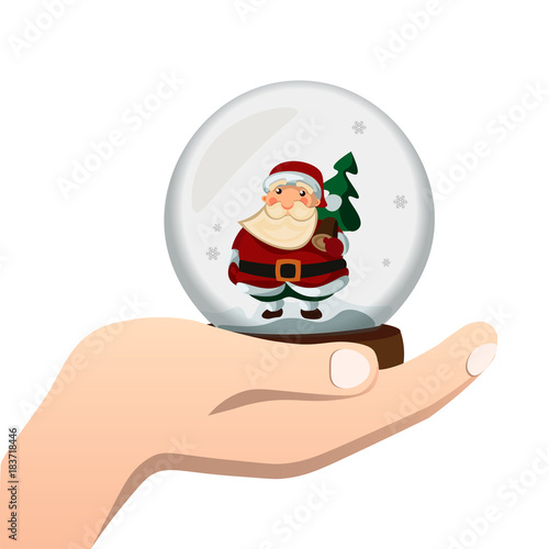 Hand holds a glass ball with Santa