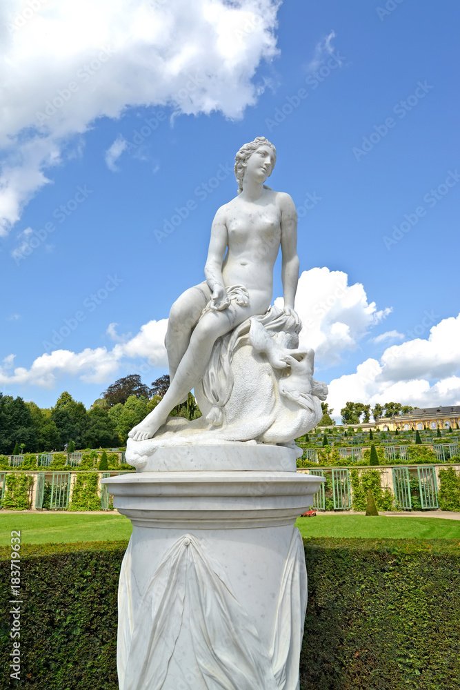 Marble sculpture against the background of grape terraces in the park of Sanssousi. Potsdam, Germany