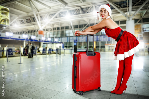 woman in red dress and sexy heels with suitcase 