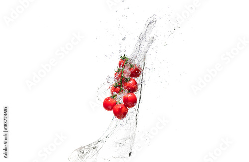  fresh cherry tomatoes in water splashes isolated on white
