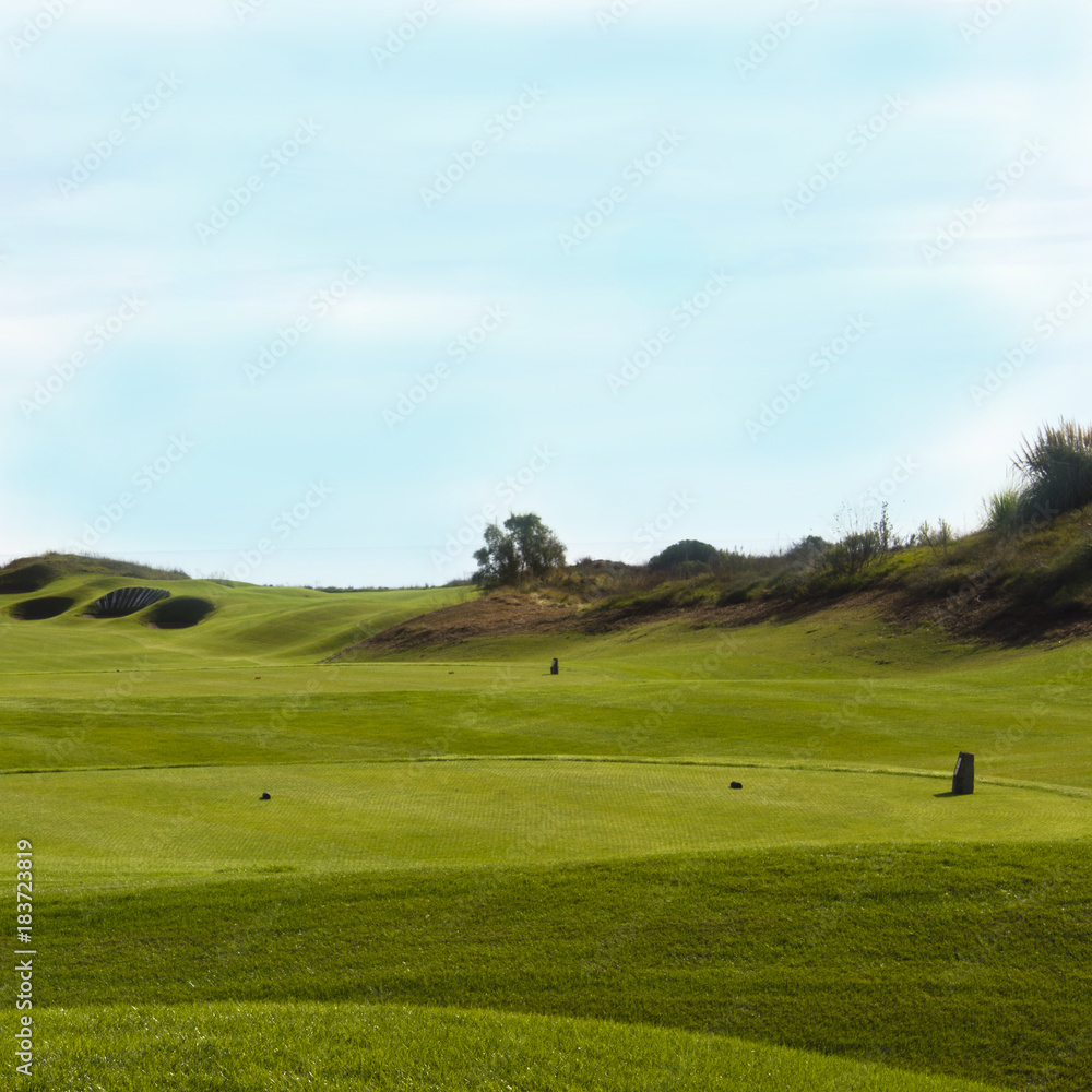 Golf course in Belek. Green grass on the field. Blue sky, sunny day