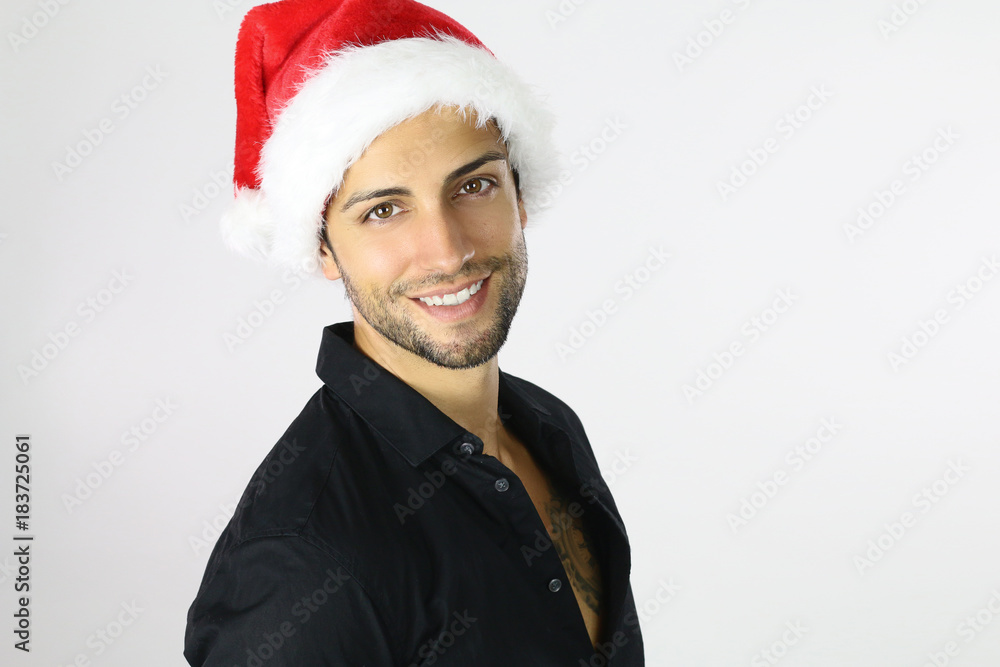 Handsome man in Santa hat on a white background Handsome man in Santa hat on a white background