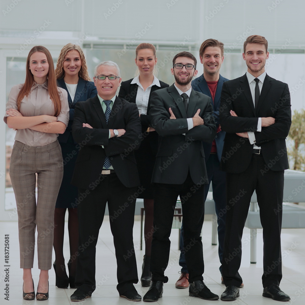 Mature businessman and cheerful business team on office backgrou