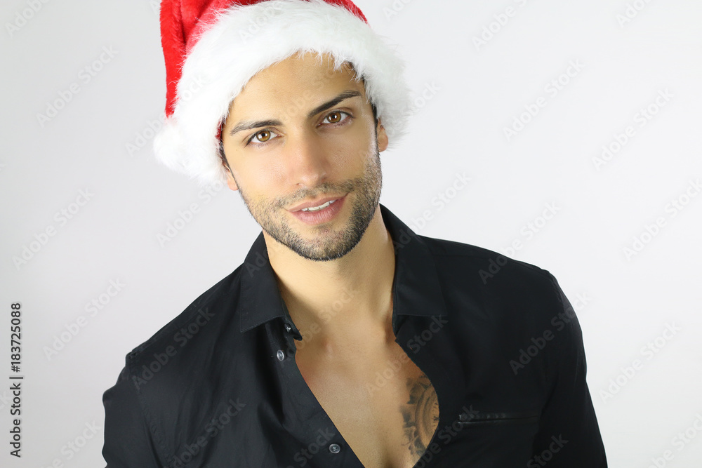 Handsome man in Santa hat on a white background Handsome man in Santa hat on a white background