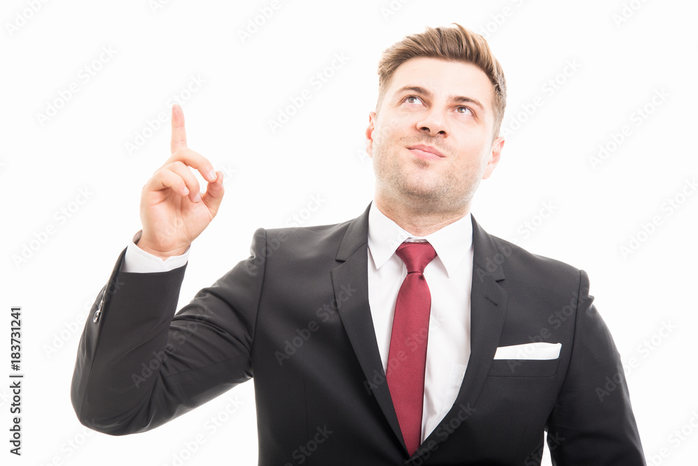 Handsome manager wearing suit pointing and looking up Handsome manager wearing suit pointing and looking up