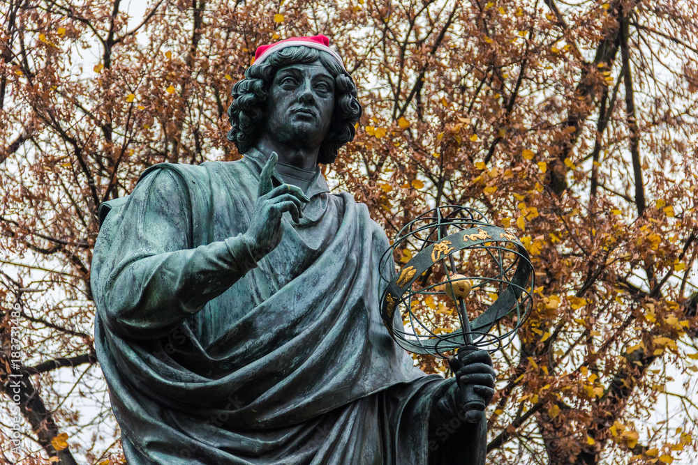Monument to Nicolaus Copernicus (1853) in academic dress holding an astrolabe, pointing to the heavens to symbolize his celestial studies. The astronomer wearing a red Santa's hat today. Torun, Poland Monument to Nicolaus Copernicus (1853) in academic dress holding an astrolabe, pointing to the heavens to symbolize his celestial studies. The astronomer wearing a red Santa's hat today. Torun, Poland