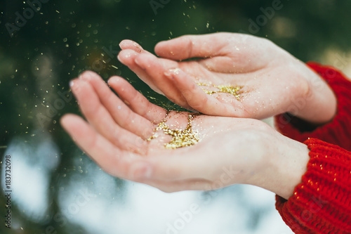 Golden glitter in hands