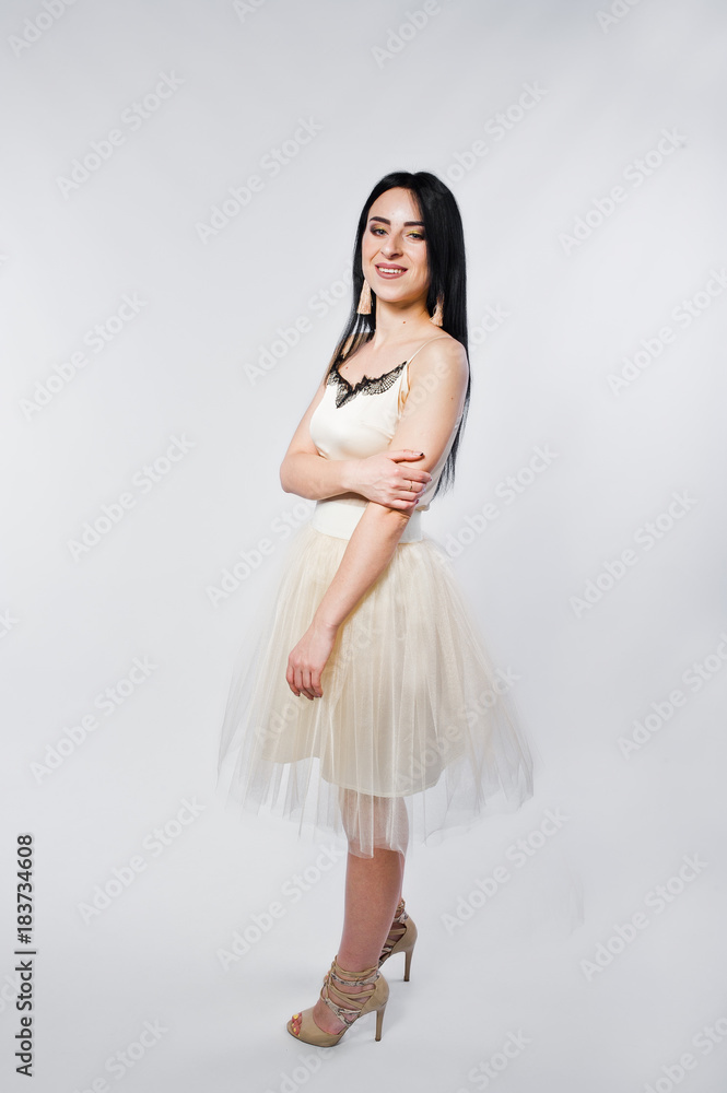 Portrait of brunette girl on beige dress isolated on white. Portrait of brunette girl on beige dress isolated on white.