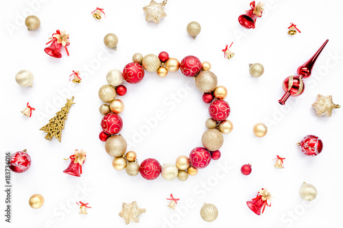 Holiday round frame, pattern made of red and gold glass Christmas balls isolated on a white background. the apartment lay, top view