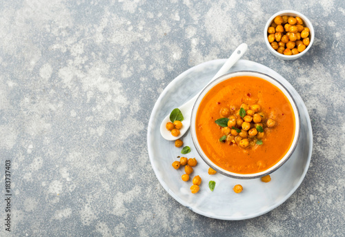Pureed vegetable soup served with roasred chickpeas, overhead shot