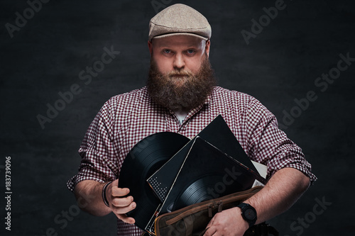 A man holds vinyl records. photo