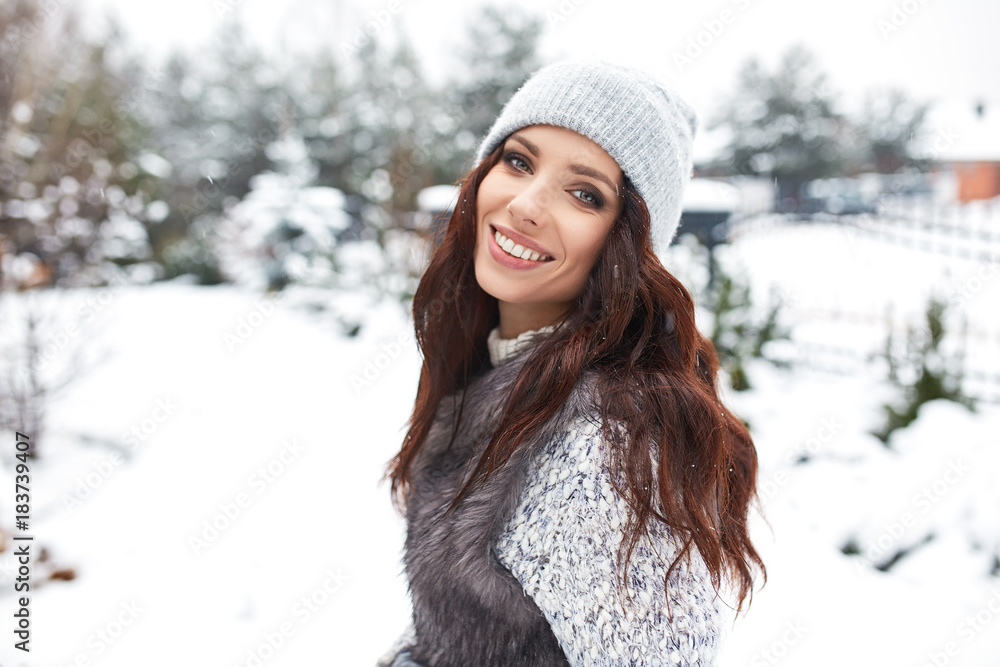 beautiful smiling young woman in wintertime outdoor. Winter concept beautiful smiling young woman in wintertime outdoor. Winter concept
