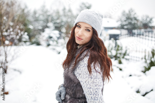 beautiful smiling young woman in wintertime outdoor. Winter concept