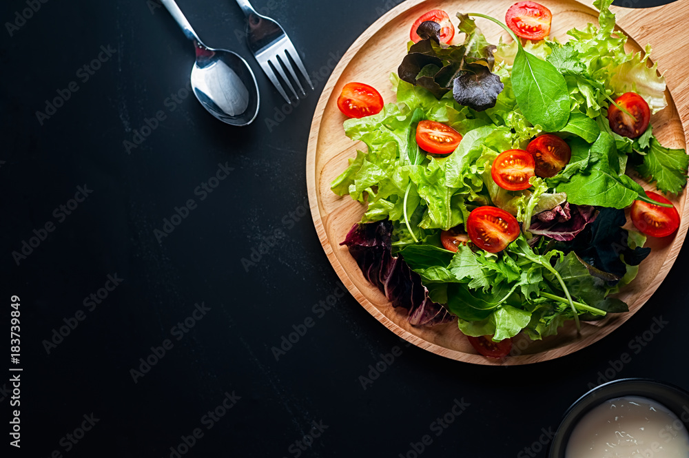 Fresh mixed vegetables salad on a wooden plate Fresh mixed vegetables salad on a wooden plate