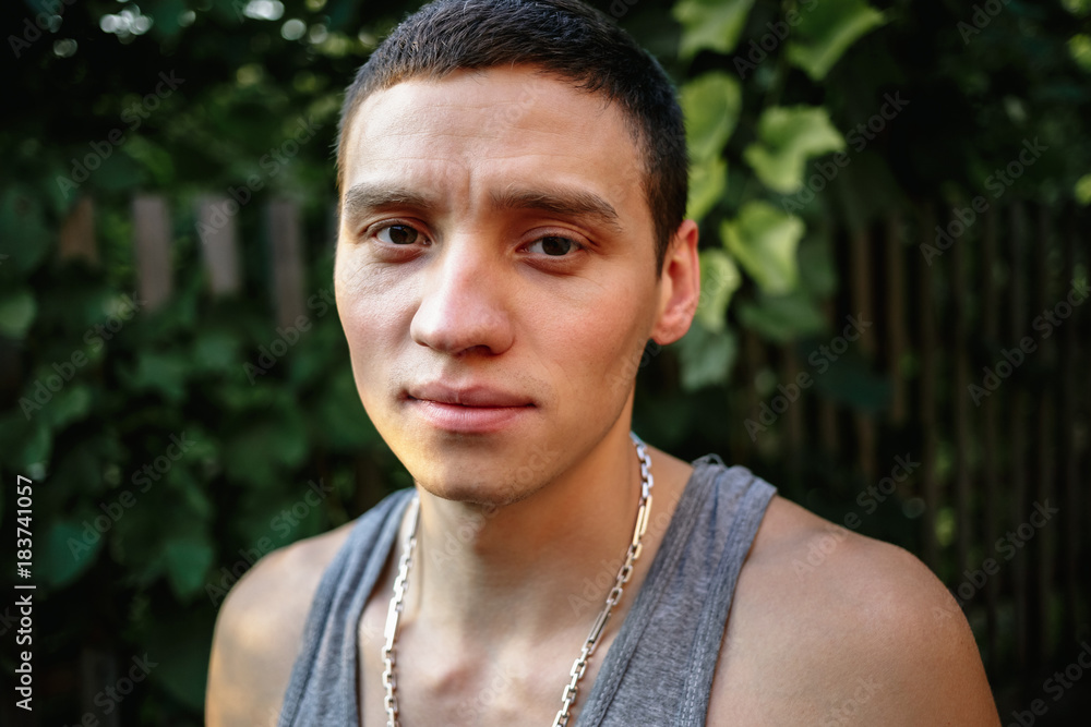 Portrait of a young man in a gray T-shirt in the countryside. Portrait of a young man in a gray T-shirt in the countryside.