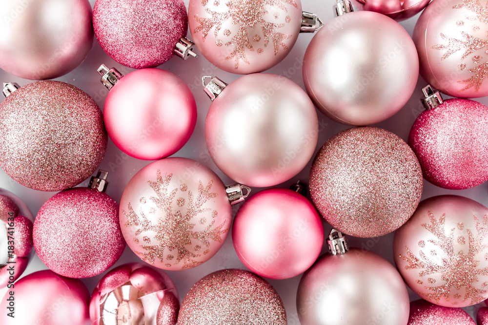 Christmas or new year texture of pink glass christmas balls on white background. Holiday and celebration concept. Top view. Flat lay Christmas or new year texture of pink glass christmas balls on white background. Holiday and celebration concept. Top view. Flat lay