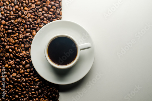 a cup of coffee, grains, books