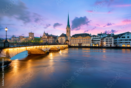 Panoramic view of historic Zurich city center with famous Fraumunster Church and river Limmat at Lake Zurich   in twilight  Canton of Zurich  Switzerland.
