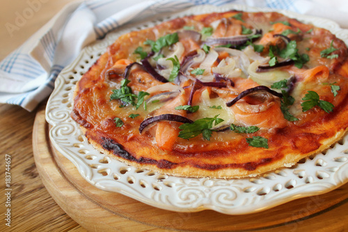 Delicious pizza with salmon and onion