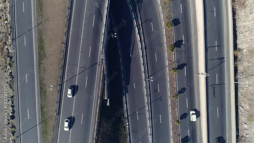 Aero shot: the concept of environmental pollution in casual megalopolis: smog, emissions, fumes on expressway with machines. The architecture of curvy autoban, many different winding turn air scene Aero shot: the concept of environmental pollution in casual megalopolis: smog, emissions, fumes on expressway with machines. The architecture of curvy autoban, many different winding turn air scene