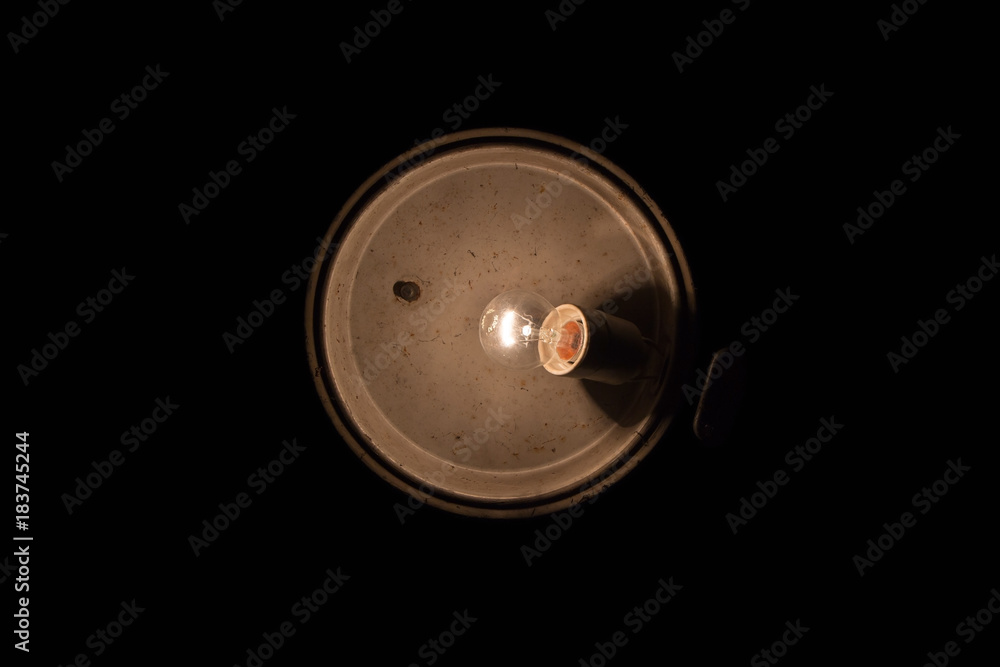 Old dirty lamp with bulb on black background Old dirty lamp with bulb on black background