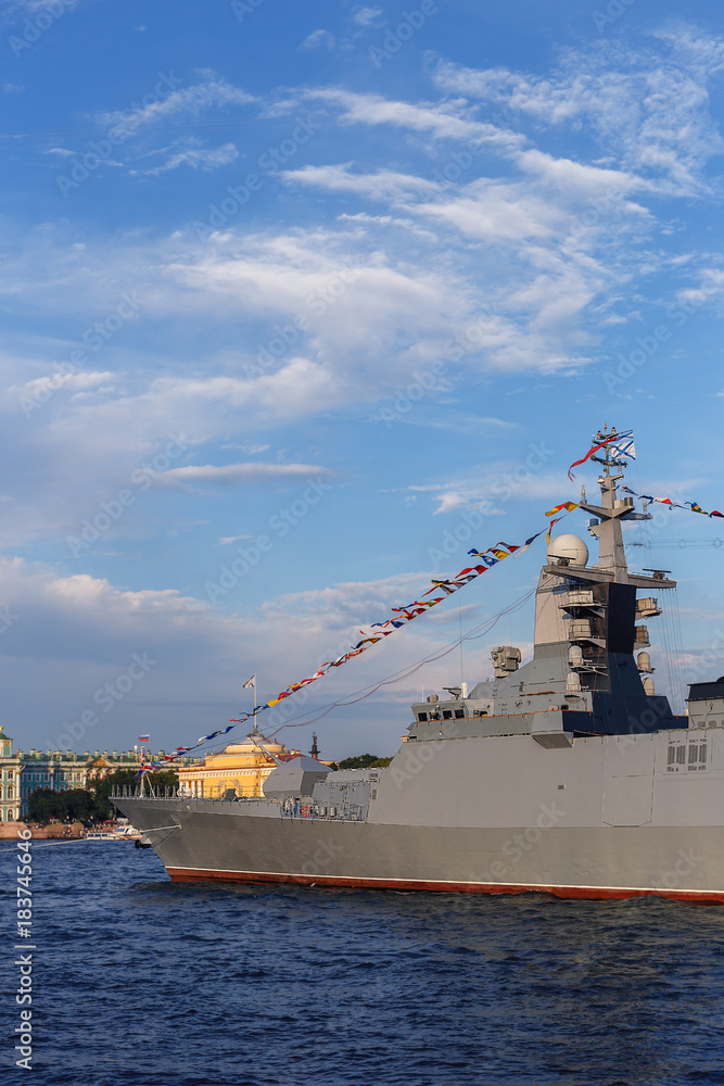 military ship on Neva river in St. Petersburg against the blue sky and the city