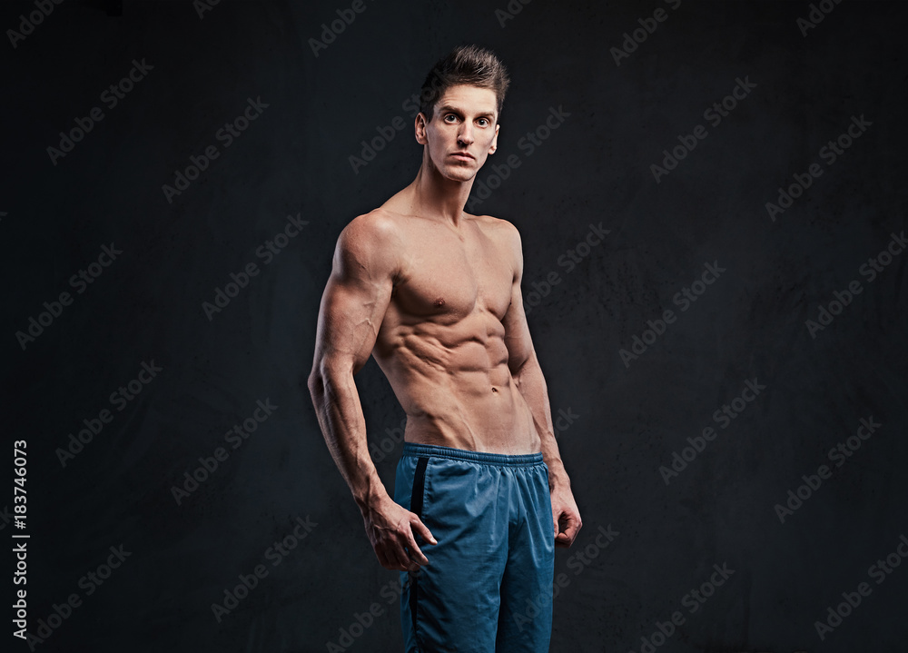 Fototapeta premium Shirtless muscular male over dark background.