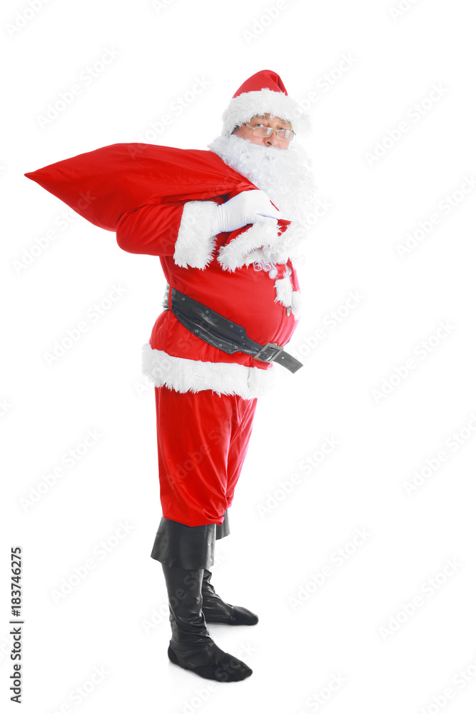 Real Santa Claus carrying big bag full of gifts, isolated on white background Real Santa Claus carrying big bag full of gifts, isolated on white background