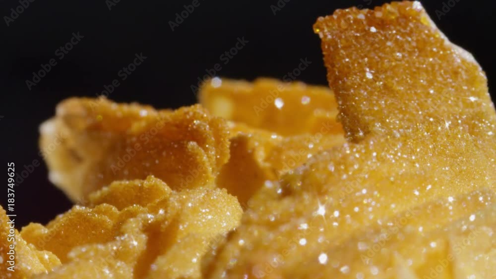CLOSE UP DOF: Sparkling golden semi precious barite vanadinite stone from Morocco. Precious brown hued rock glimmering with gold undertones. Detailed shot of rough golden precious barite vanadinite. CLOSE UP DOF: Sparkling golden semi precious barite vanadinite stone from Morocco. Precious brown hued rock glimmering with gold undertones. Detailed shot of rough golden precious barite vanadinite.