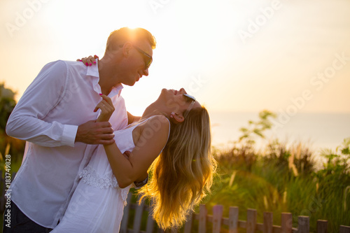 Lovely couple dancing outside in sunset