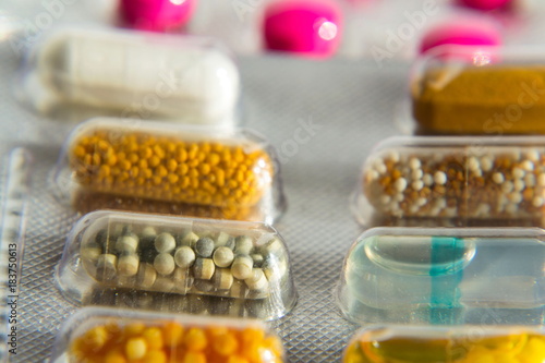 Colorful pills in transparent medicine capsule, nanotechnology future medicine concept