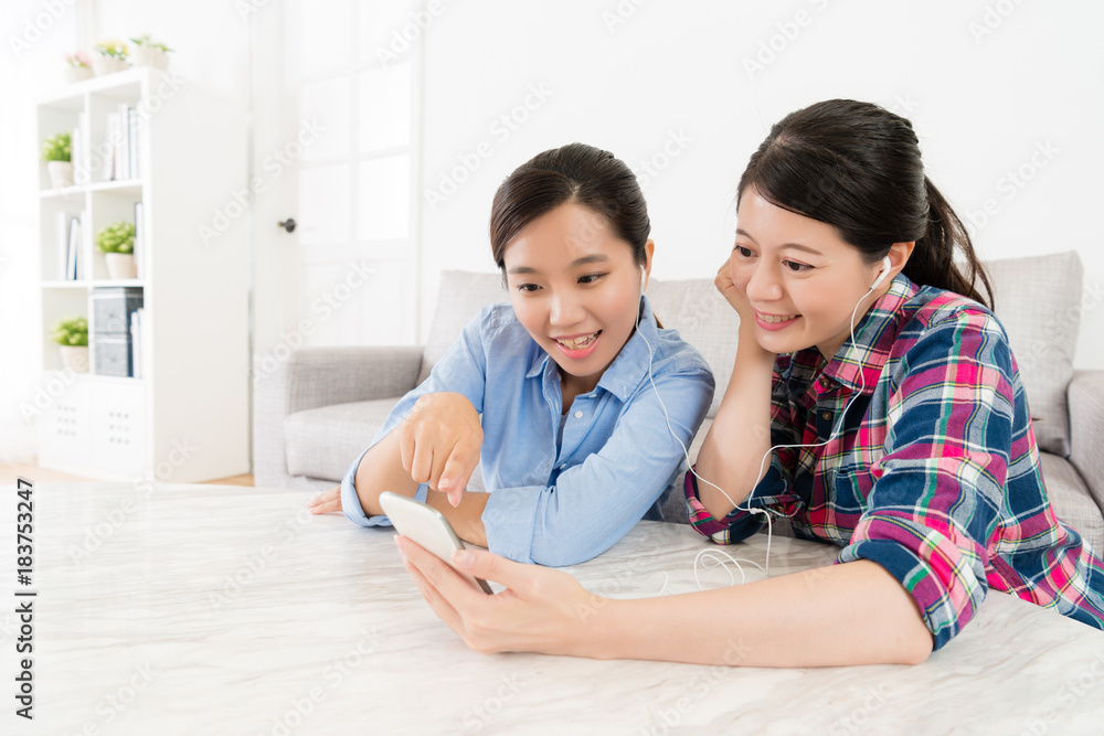 elegant young sisters using mobile cell phone elegant young sisters using mobile cell phone