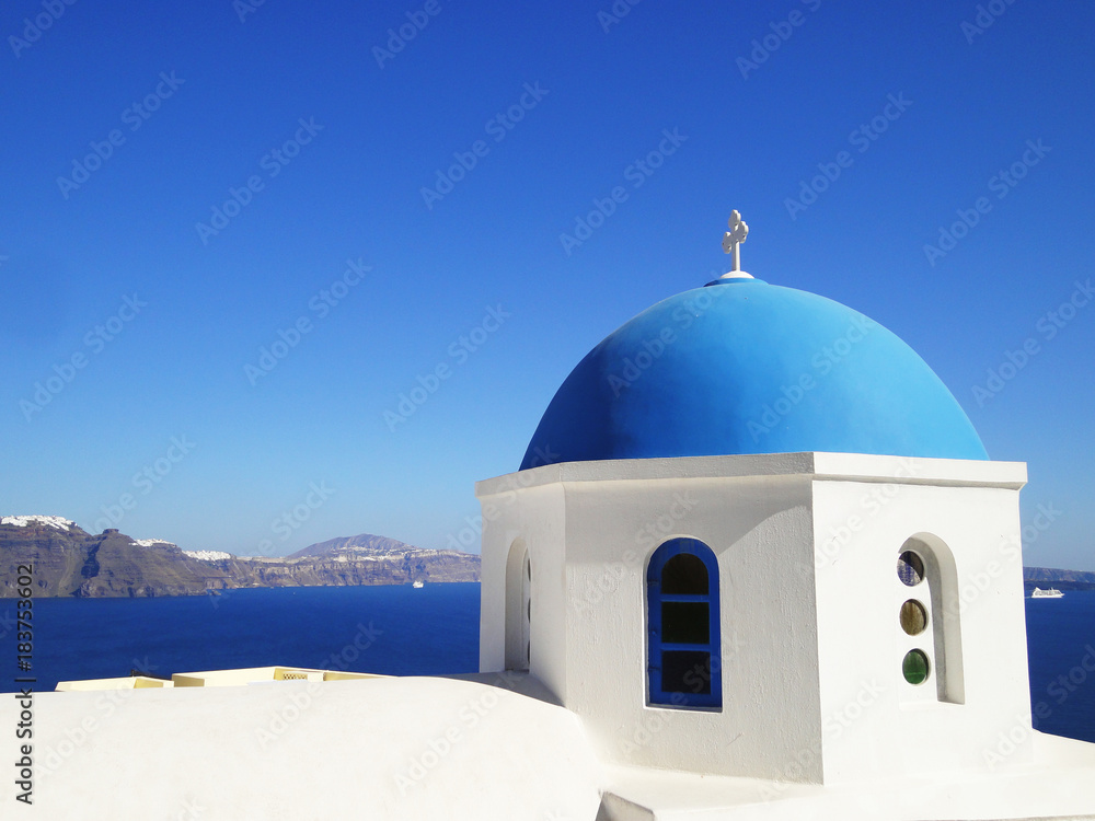 Blue dome church frequently seen in Santorini Greece