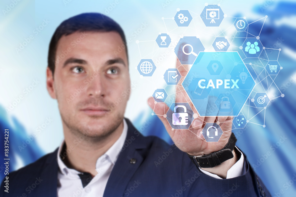 Business, Technology, Internet and network concept. Young businessman working on a virtual screen of the future and sees the inscription: Capex Business, Technology, Internet and network concept. Young businessman working on a virtual screen of the future and sees the inscription: Capex