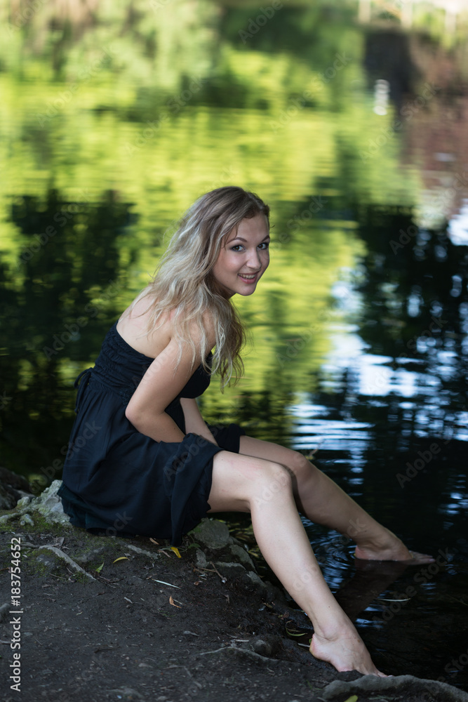 Young beautiful woman over the colorful water surface Young beautiful woman over the colorful water surface