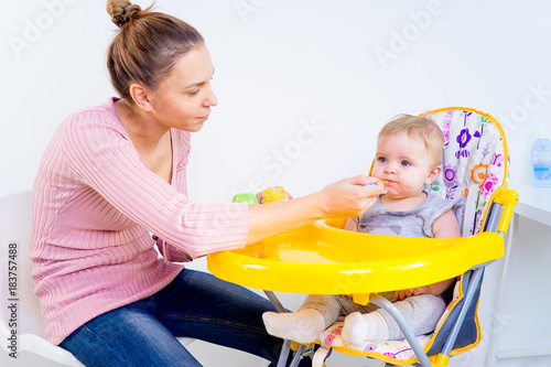 Mother feeding her daghter photo