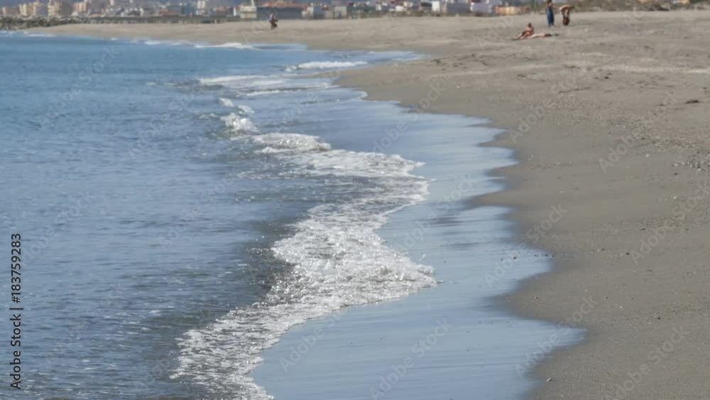 Waves of the Mediterranean Sea are washed by sandy shore near the Strait of Gibraltar Waves of the Mediterranean Sea are washed by sandy shore near the Strait of Gibraltar