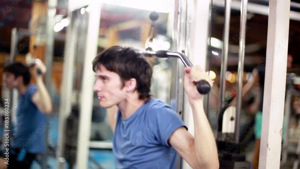 Handsome athletic young male does exercises at gym. 1920x1080 Handsome athletic young male does exercises at gym. 1920x1080