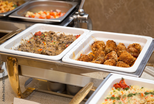 Containers with hot food at the banquet. Pilaf, chicken, beef, vegetables - hot dishes, self-service. buffet breakfast
