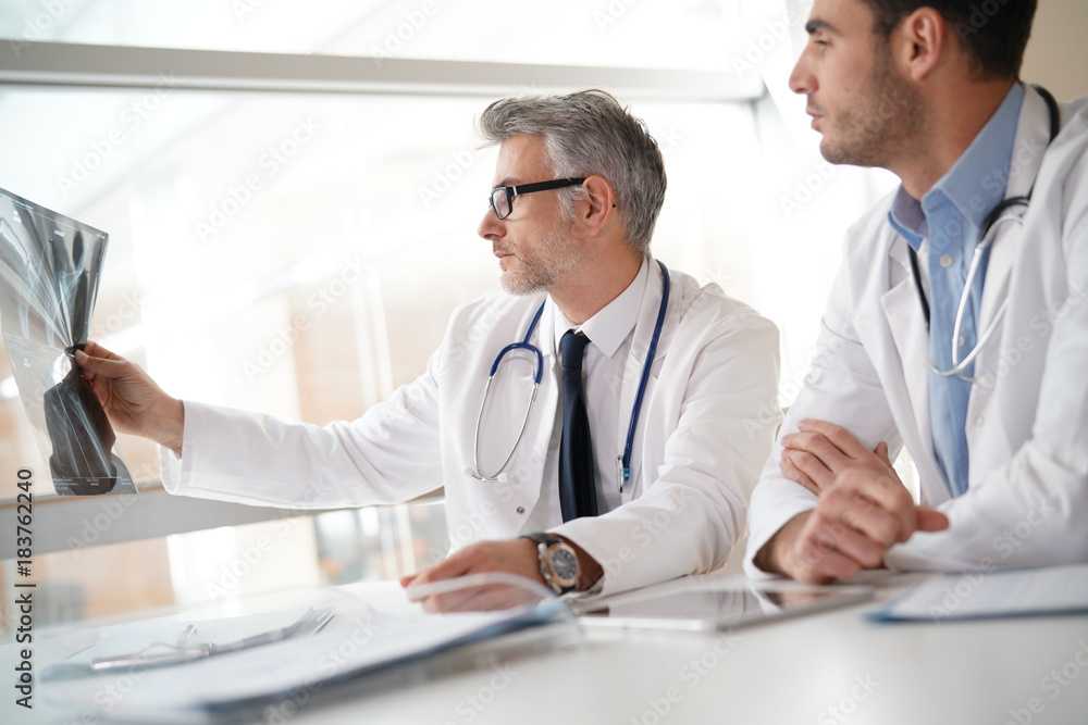 Doctors in office working on medical report Doctors in office working on medical report
