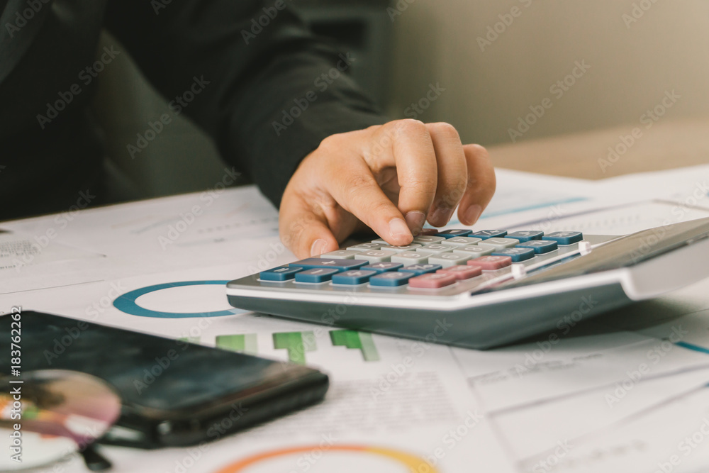 Close up hand of businesswoman accountant or banker using calculator, business finance calculation concept Close up hand of businesswoman accountant or banker using calculator, business finance calculation concept