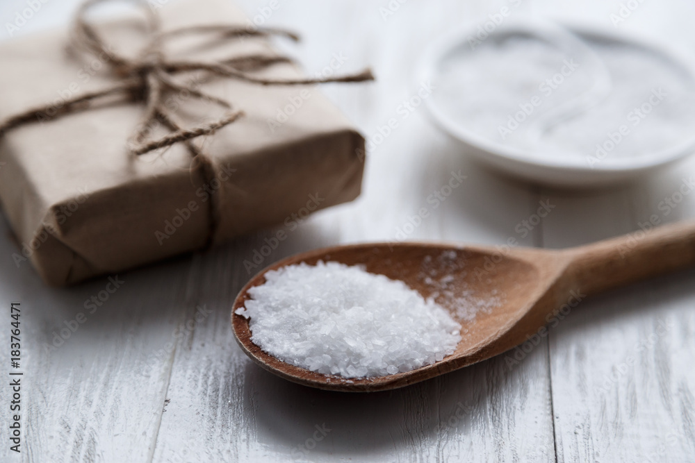 sea salt on wooden background with gift box. sea salt on wooden background with gift box.