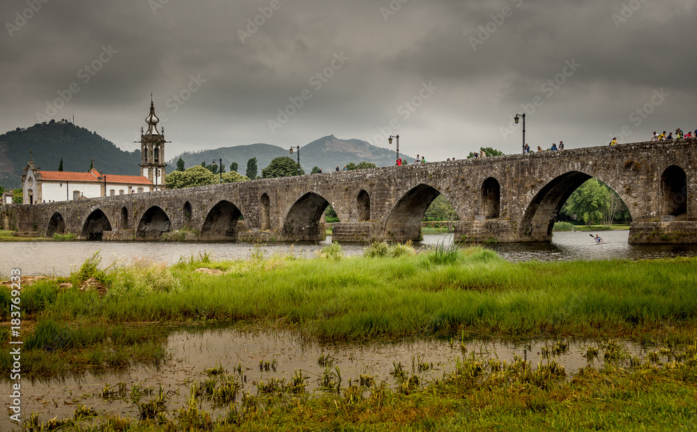 The old bridge over the river. Arches. Portugal.