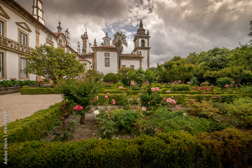 n the old park. Beautiful flower bed, roses. Portugal.